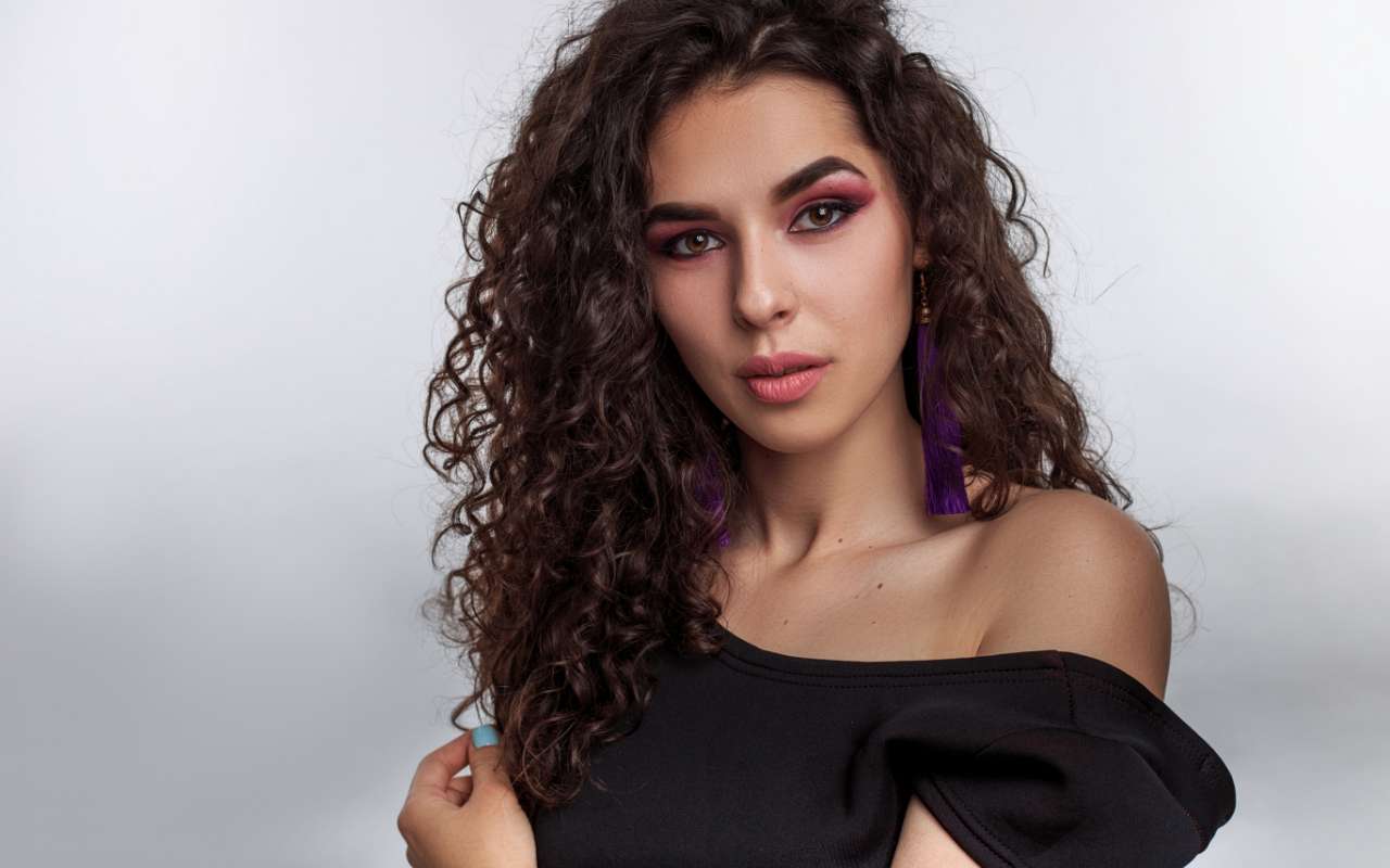 Pretty Woman With Wavy Hair Wearing A Black Dress