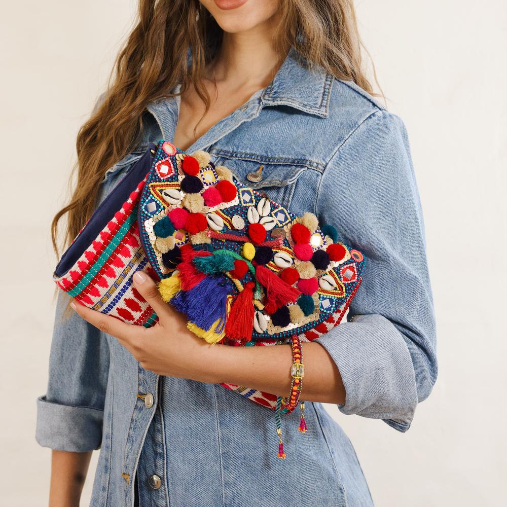 Colourful Boho Flap Over Statement Clutch Featuring Pom Pom and Tassel Bead Detatiling on model