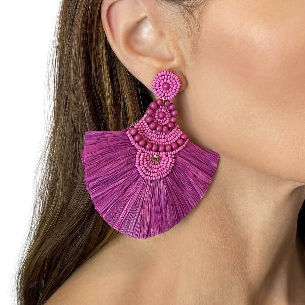 Large mixed bead and raffia magenta statement earrings on model