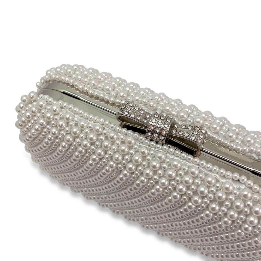 Pearl covered hard event clutch featuring silver diamante bow clasp