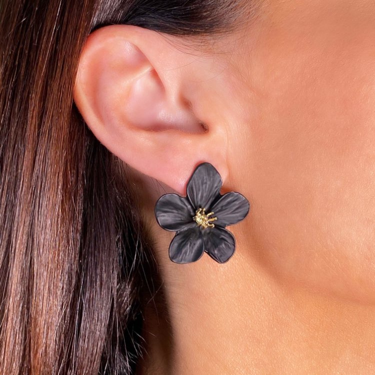 Black flower stud earrings on model