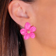 Pink flower stud earrings on model side view