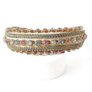 Luxurious crepe fabric padded headband Heavily jeweled in a opal blue and blush rhinestones