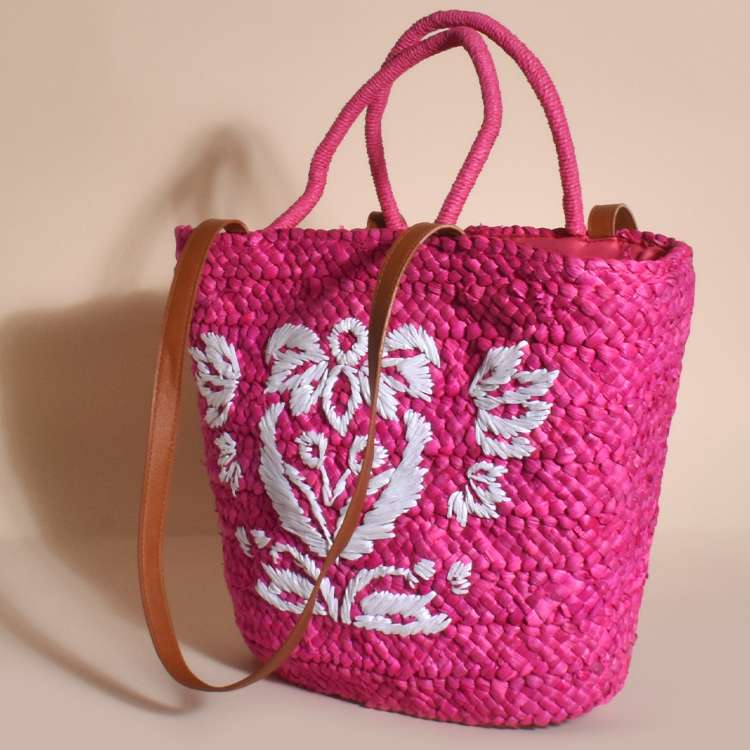 Woven basket bag Zip top closure Internal pockets Double handle strap Stitched embroidered front detail in pink