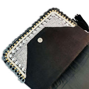 Open view of Black canvas flap over clutch with Mixed metallic beading and Black faux suede tassels plus a Magnetic closure