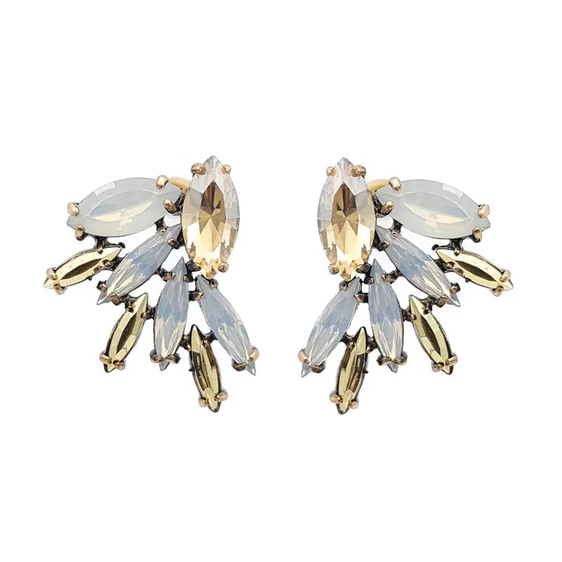 Amber rhinestone stud earrings Featuring milk opal and gold rhinestone detailing Set in plated vintage gold