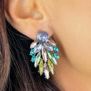 Close up of model wearing pastel diamante earrings