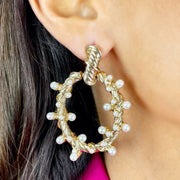 Close up of model wearing Gold Twisted Hoop Earrings with Pearl Detailing