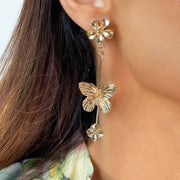 close up picture of model wearing Brushed gold alloy Flower stud earrings with Delicate butterfly design