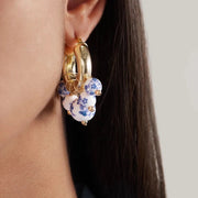 Gold hoop earrings Featuring white and blue hand painted flower beads
